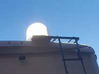 Dish sat nounted to ladder.  No holes in roof.