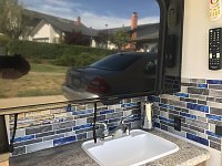 Put some stick on lightweight backsplash to the outdoor kitchen area. Colors match the side decals on the coach.