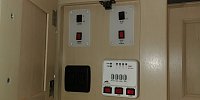 This is the main control panel at the entrance.  Awning and slide controls, lights, water pump, and water heater controls.  The level indicators are very crude, but work.