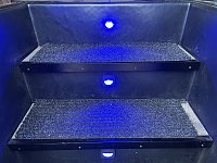 Blue step lights, inspired by marine applications on board boats. Actuated whenever the outdoor light is on. Now if I get a lawsuit for falling down the stairs, I can argue I mitigated the danger as...