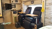 Added dual swivel euro recliners and tables using Lagun table mounts to the above floor slide and added extended TV mount for viewing ease.