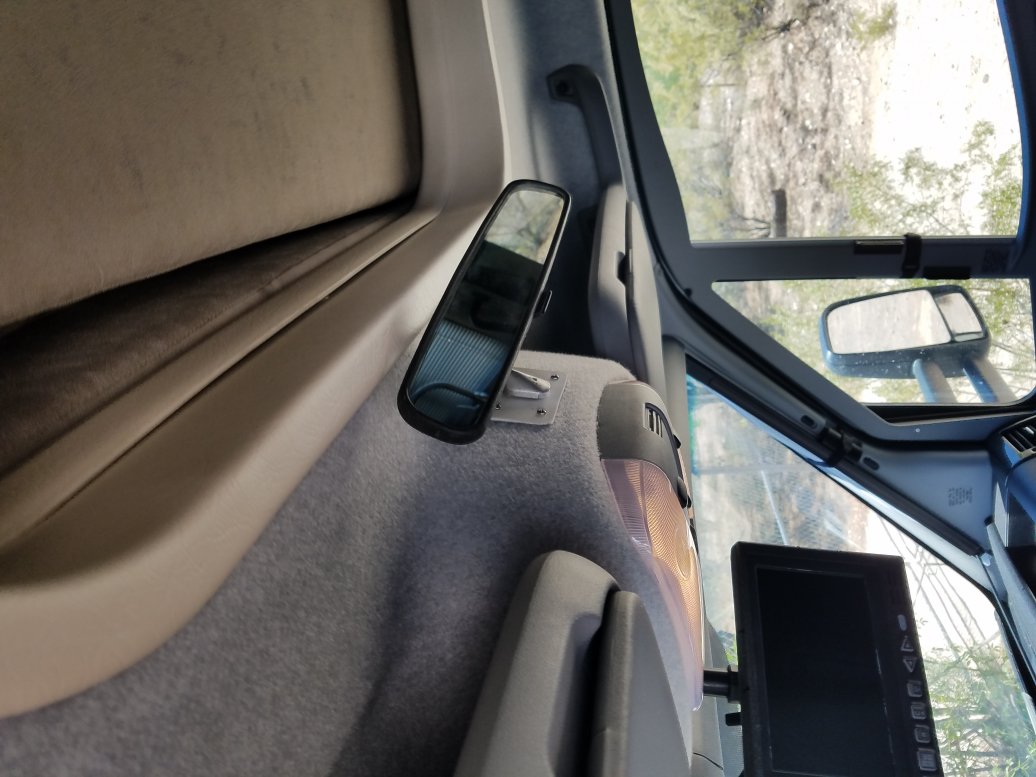 Added a rear view mirror to see the dogs while traveling.  Note the new monitor below the mirror.  I can view the new rear view camera and the two side view cameras all the time.  Not just when turning or in reverse.