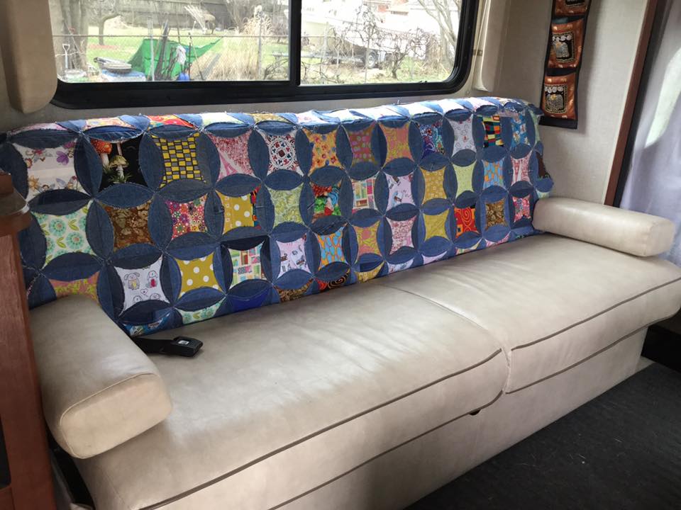 I made this quilt from my husbands old blue jean to go  on the RV sofa.  It slides all over so it's now on one of the bunks.