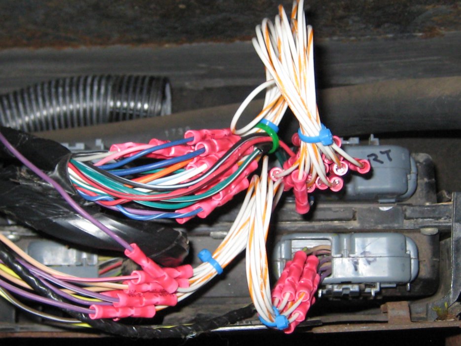 After several hours lying on the engine with a crimping tool in hand, and a total of 104 crimps, the squirrel-eaten wires were replaced. Saved about $1,200 doing it myself.
IMG 1225
